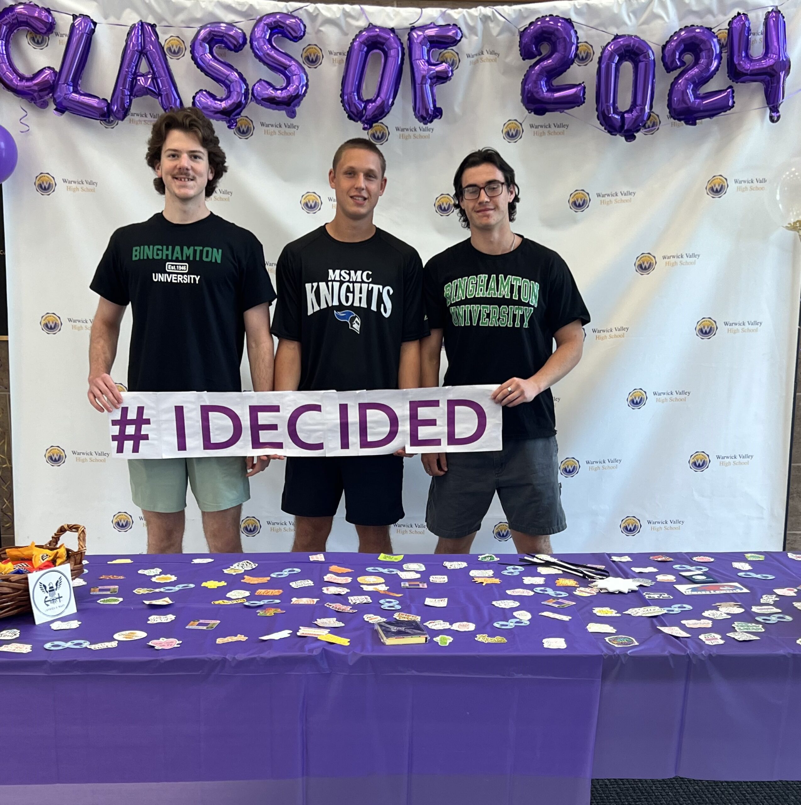 Three WVHS seniors hold an "I DECIDED" banner on Decision Day, celebrating the Class of 2024 and the choices they’ve made about their post high school lives.