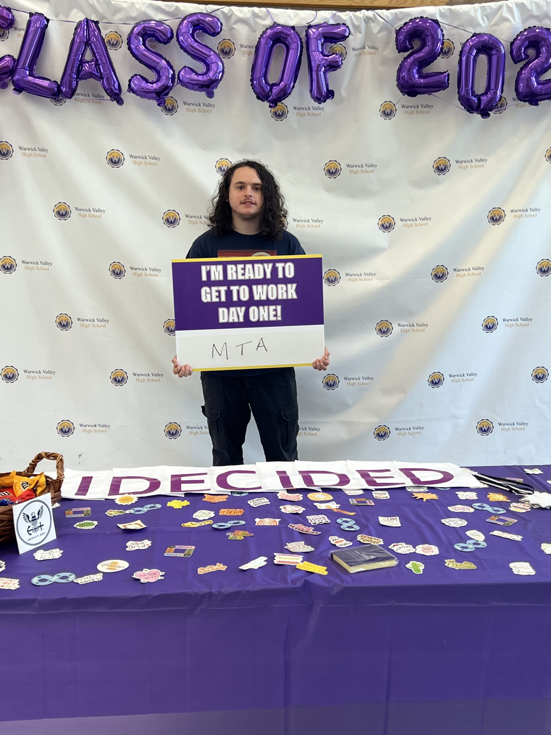 A WVHS senior holds an "I DECIDED" banner on Decision Day, celebrating the Class of 2024 and the choices they’ve made about their post high school lives.