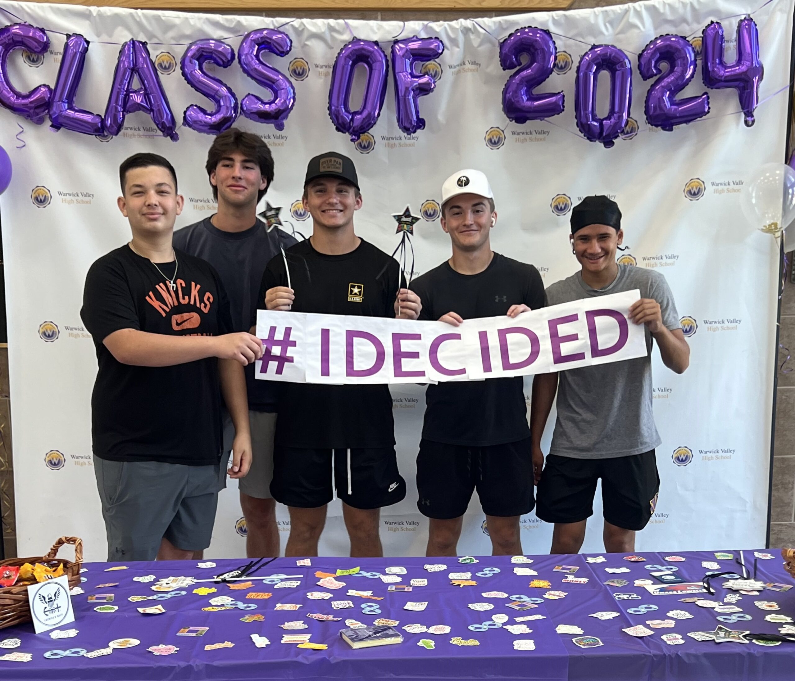 Five WVHS seniors hold an "I DECIDED" banner on Decision Day, celebrating the Class of 2024 and the choices they’ve made about their post high school lives.