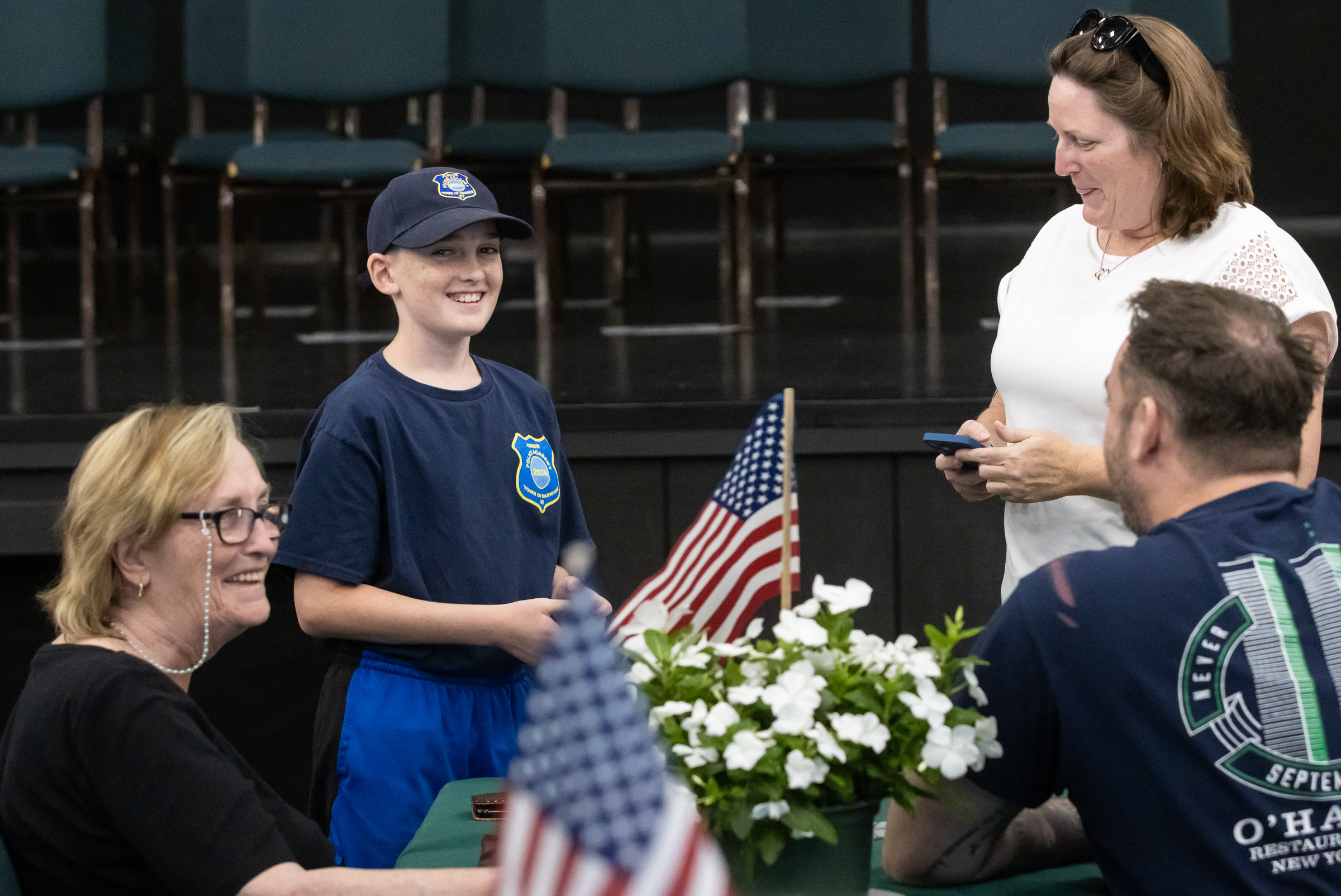 A cadet smiles with his family after graduating from the Town of Warwick Police Department Junior Police Academy.