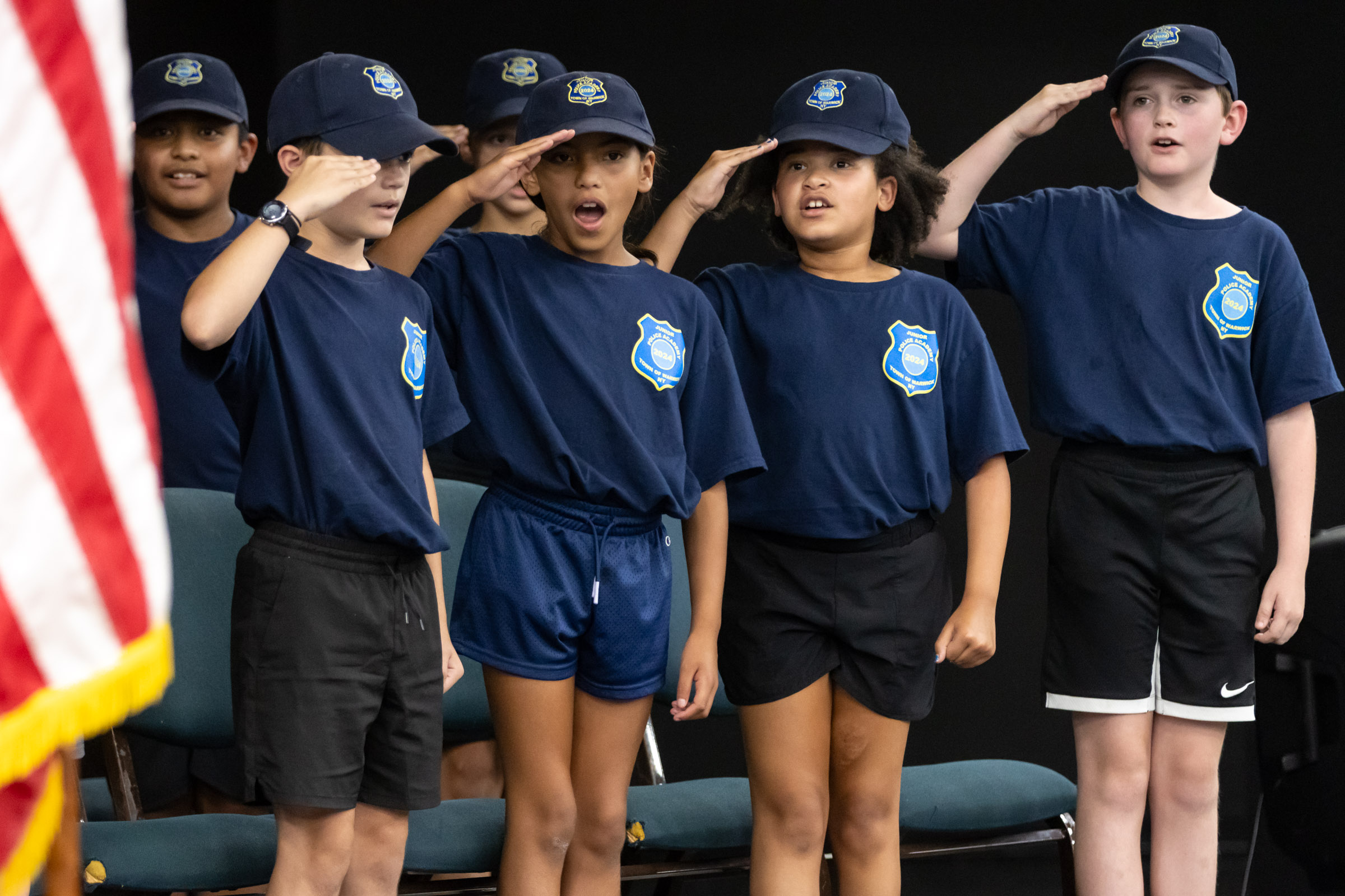 Town of Warwick Junior Police Academy cadets salute at the end of their graduation.