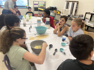 students stirring batter for pancakes