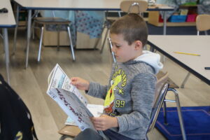 student reading graphic novel