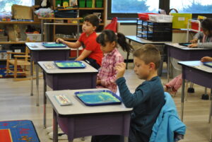 students participating in sand activity