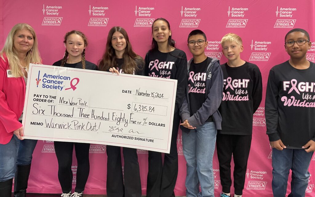 Students giving a donation check for more than $6,000 to the American Cancer Society