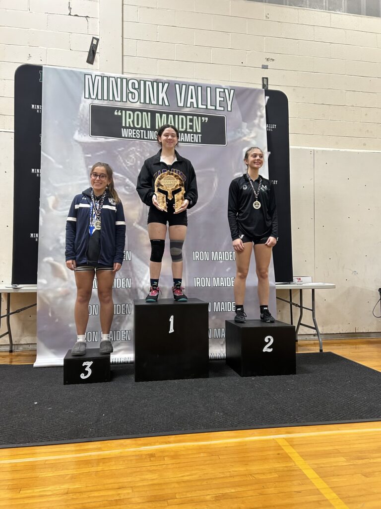 Girls wrestlers on the podium at the Iron Maiden Tournament.