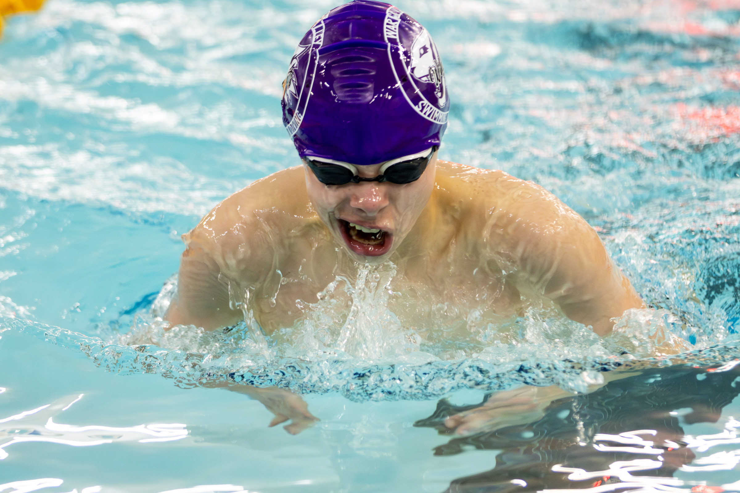 Warwick swimmer competes in a varsity meet against Goshen.